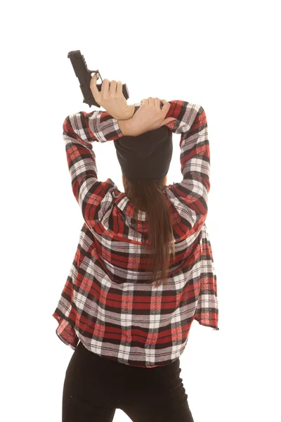 Woman in beanie and plaid shirt back gun — Stock Photo, Image