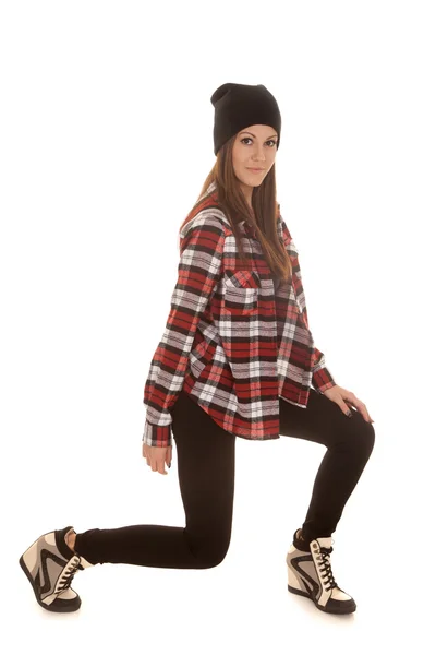 Woman in beanie and plaid shirt posing — Stock Photo, Image