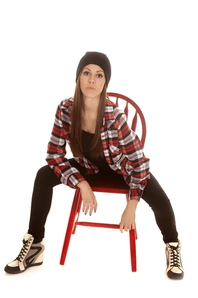 Woman in beanie and plaid shirt sit lean forward — Stock Photo, Image