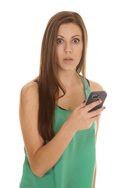Woman in green top with phone shock look Stock Photo