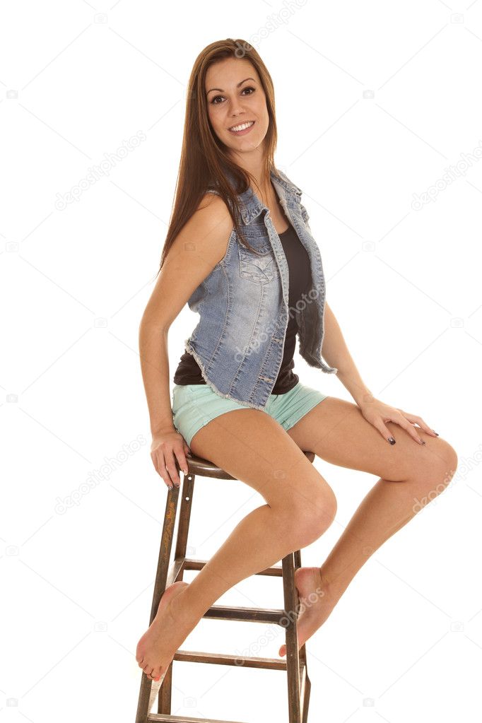 Woman denim vest sit stool smile Stock Photo by ©alanpoulson 41161537