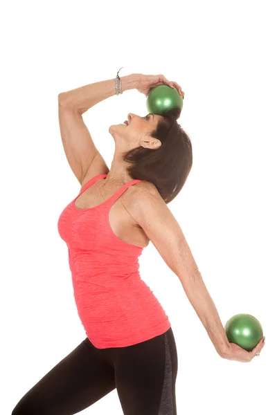 Older woman green balls fitness one on head — Stock Photo, Image