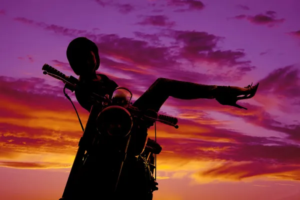 Silhouette woman on motorcycle sit side legs up — Stock Photo, Image