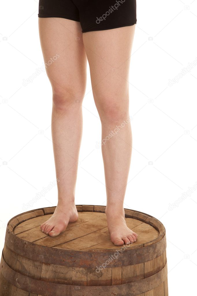 woman legs on barrel standing