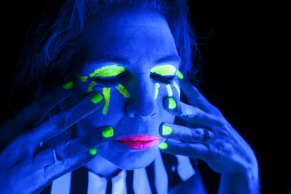 Woman black light eyes closed hands on face — Stock Photo, Image