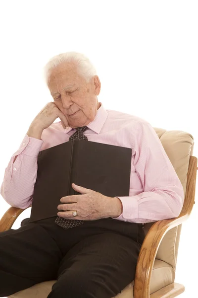 Elderly man pink shirt book sleep — Stock Photo, Image