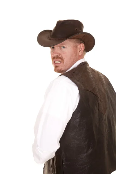 Cowboy in vest and hat look over shoulder — Stock Photo, Image