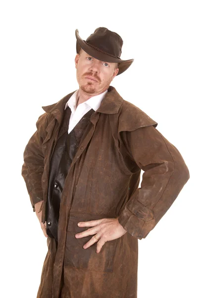 Cowboy with hat and duster hands on hips serious — Stock Photo, Image