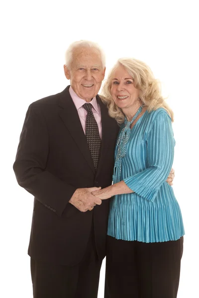 Elderly couple dressed up hold hands — Stock Photo, Image