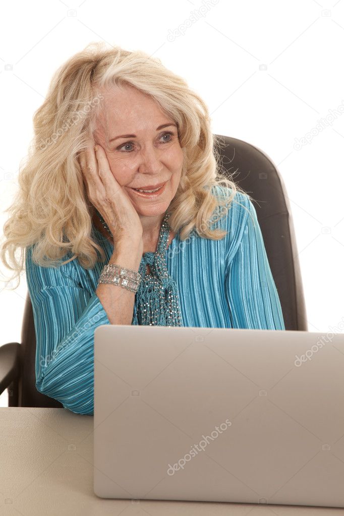 elderly woman blue shirt computer look side