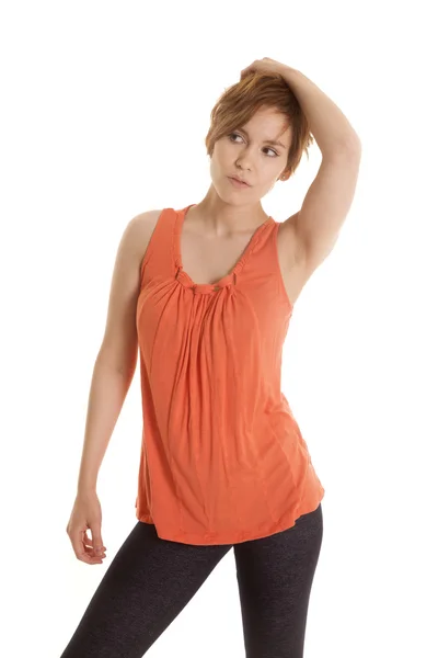 Latin woman orange shirt stand look side — Stock Photo, Image