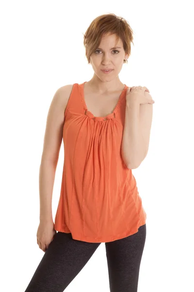 Latin woman orange shirt stand looking smile — Stock Photo, Image