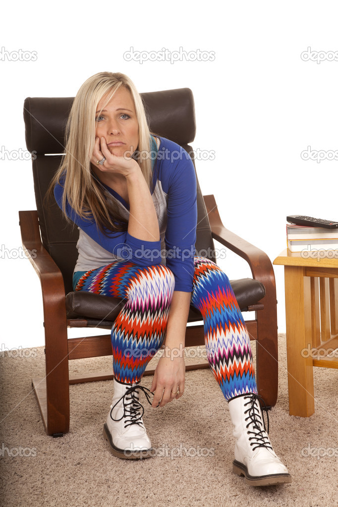 Woman colorful pants sit bored hand chin