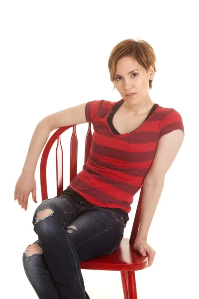 Latin woman red shirt sit chair arms down — Stock Photo, Image