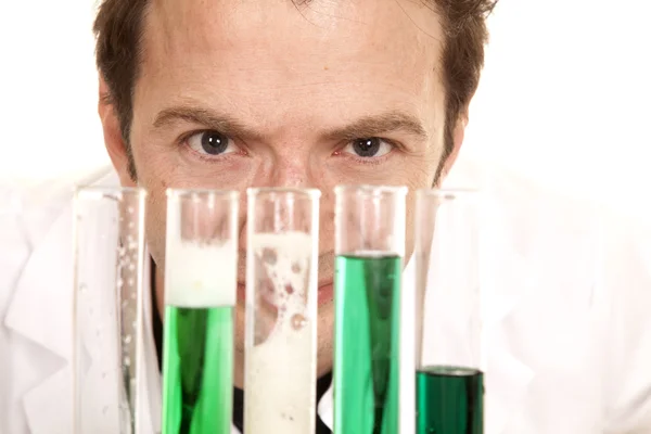 Mad scientist look over test tubes close — Stock Photo, Image