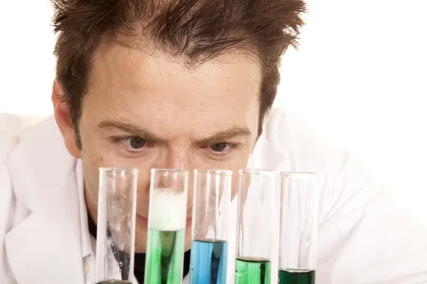 Mad scientist look at test tubes close — Stock Photo, Image