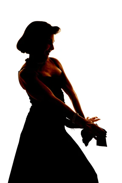 Mulher silhueta em um vestido mãos fora — Fotografia de Stock