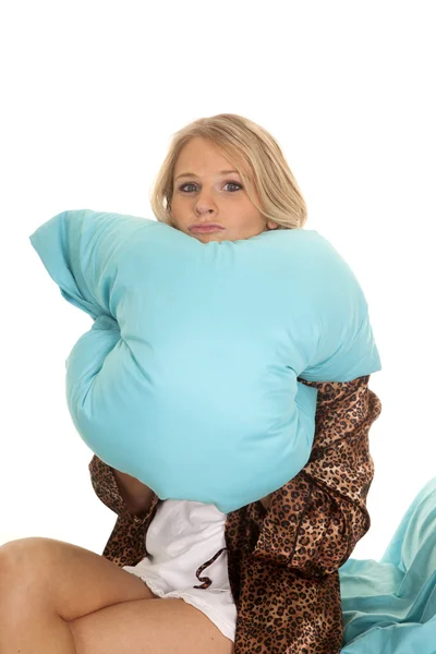 Woman in animal print robe blue sheets chin on pillow — Stock Photo, Image