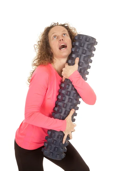 Fitness woman pink top hug roll look up — Stock Photo, Image