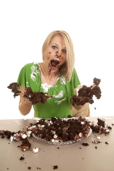 Woman green shirt with cake mouth open hands out messy — Stock Photo, Image