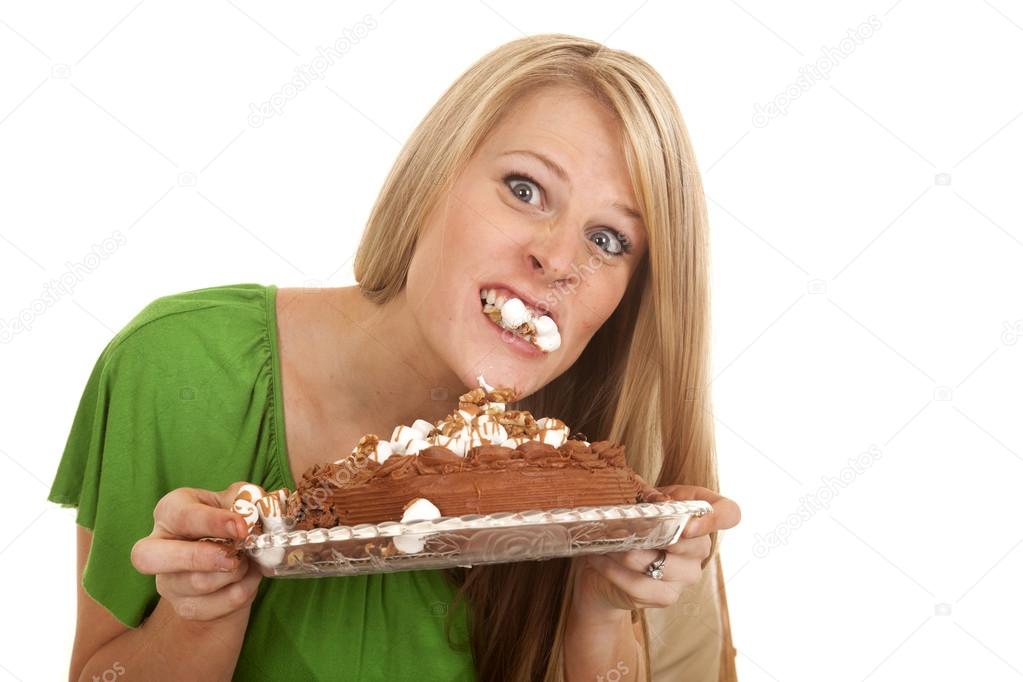 woman green shirt with cake bite in mouth