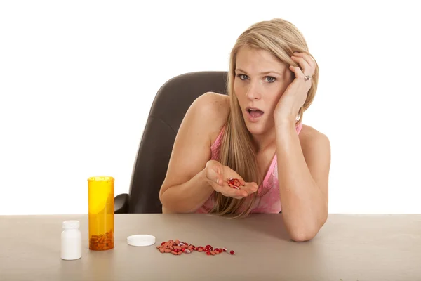 Woman pink tankk top pills in hand — Stock Photo, Image