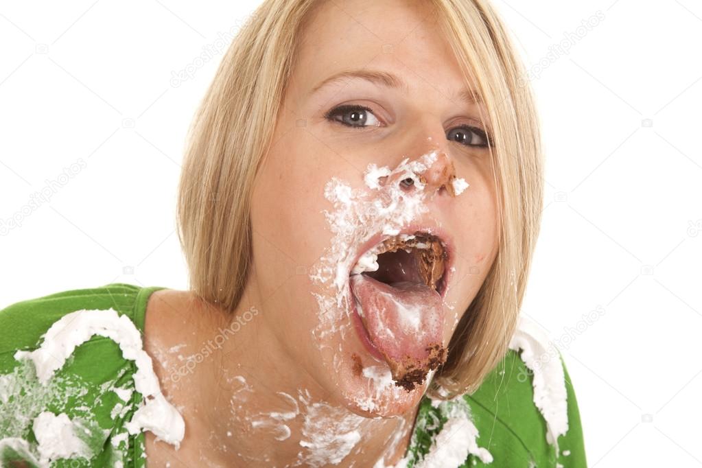 woman green shirt with whip cream on her face and shirt