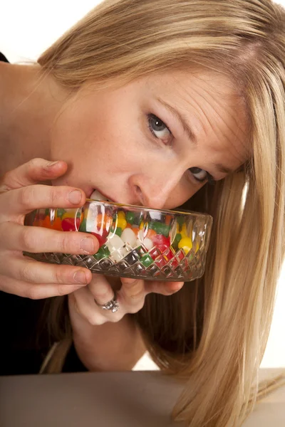 Woman eating jellybeans mouth in bowl — Stock Photo, Image