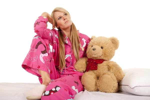 Žena růžové pyžamo medvěd sedí boční pohled — Stock fotografie