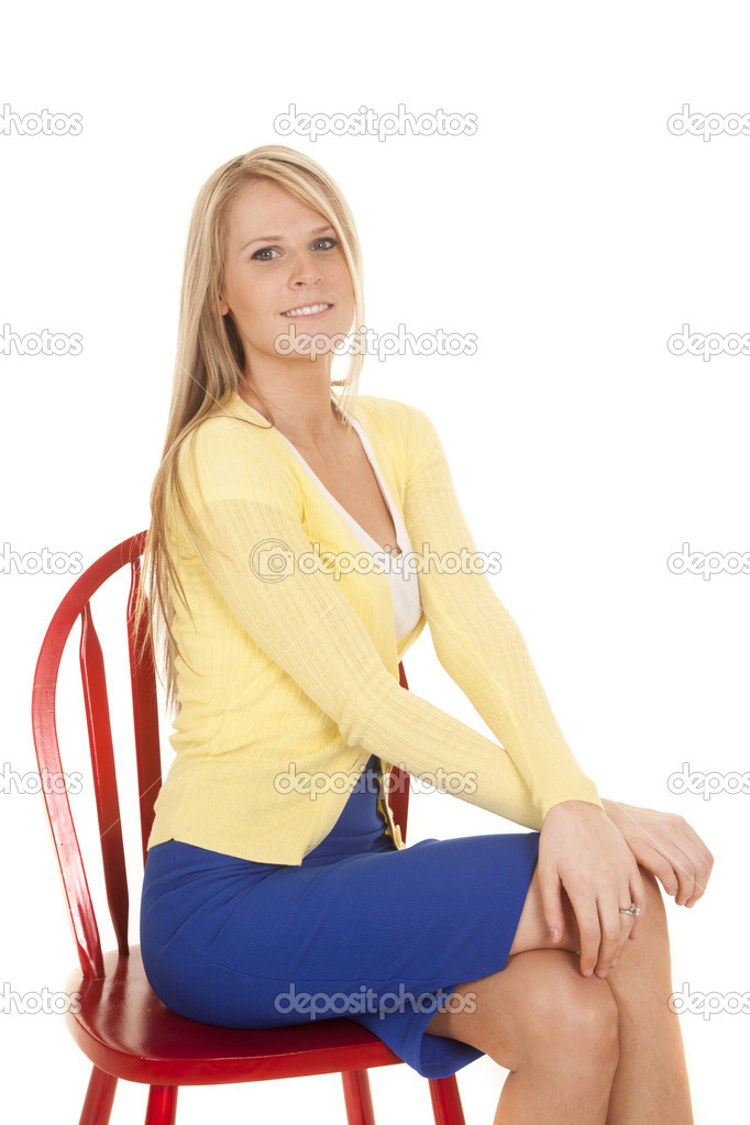 Woman in yellow and blue sit on red chair