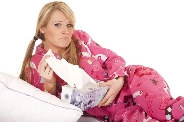 Woman pink pajamas tissue pull frown — Stock Photo, Image