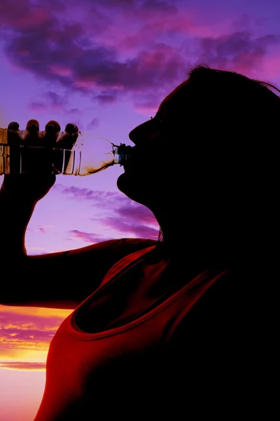 Woman silhouette drinking — Stock Photo, Image