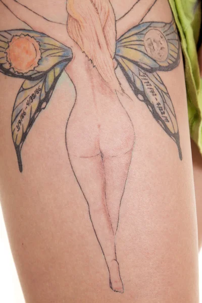 Woman show legs fairy tattoo — Stock Photo, Image