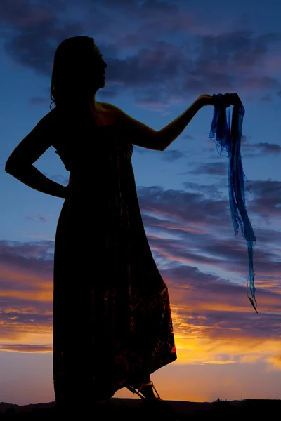 Silhouette of a woman holding out a sarong — Stock Photo, Image