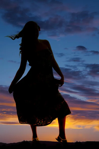 Silhouette of a woman hold skirt — Stock Photo, Image