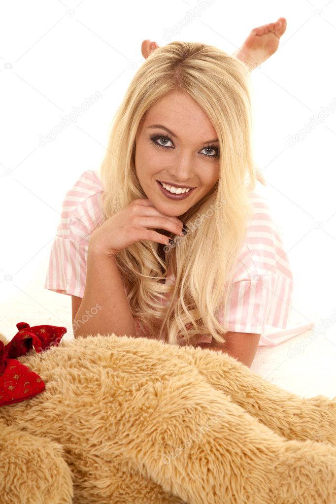 Woman laying down by her teddy bear