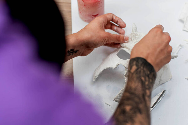 creating masks based on a plaster cast. Gypsum mold. Cast of the face. Sculpting. The workflow of the artist. Preapearing to halloween.