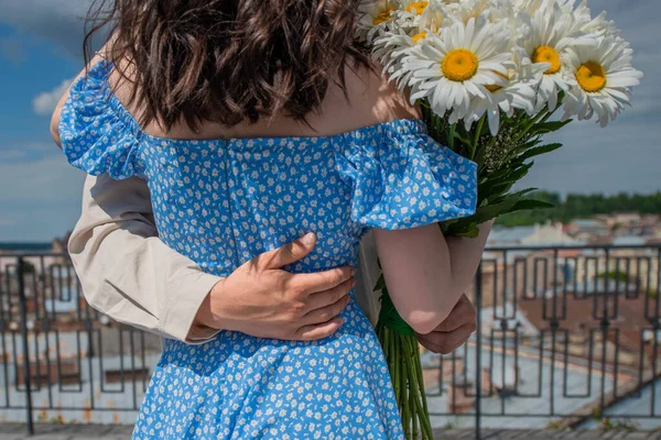 Man Hugs Gently Supports Woman Blue Dress Daisies Background View — ストック写真