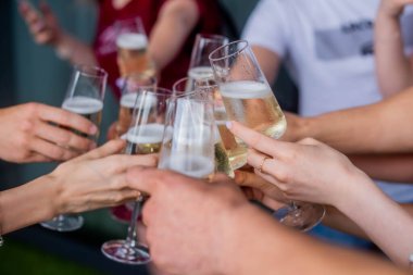 friends clink champagne glasses. Bride with jewelry and wedding ring