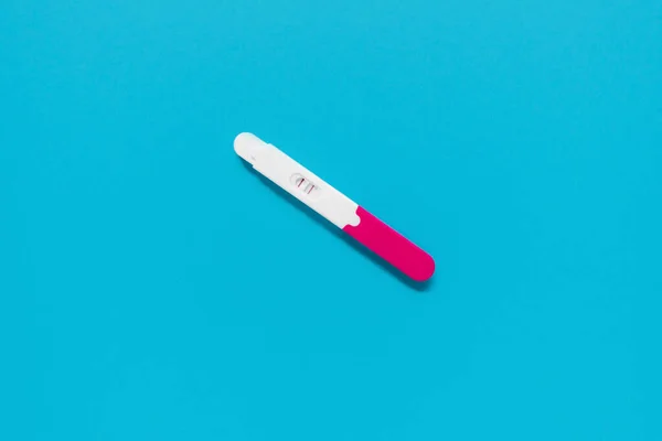 positive pregnancy test on a blue background