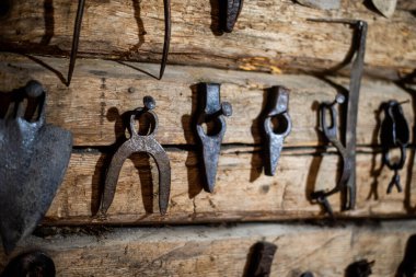Workshop scene. Old tools hanging on wall in workshop. Vintage garage style