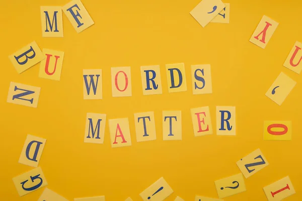 Word from letters words matter on yellow background. Flat lay.