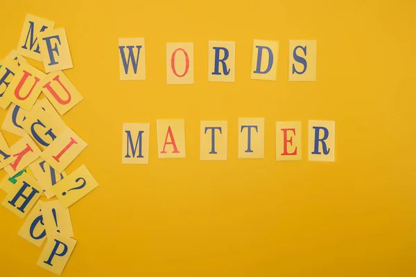 Word from letters words matter on yellow background. Flat lay.