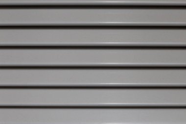 perpendicular view of an aluminum shutter with gray painted strips