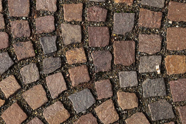 perpendicular view of a porphyry tile pavement in a medieval Italian square