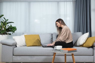 Genç hasta üniversiteli kadın evde oturup bilgisayarındaki video konferans görüşmesi için çevrimiçi derse hazırlanıyor. Çevrimiçi internet iş eğitimi, sağlık konsepti.