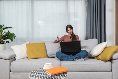 İnternetteki terapi seanslarından sonra psikoterapist doktoruyla görüntülü konuşma yapan genç bir kadın teletıp konuşmalarından sonra iyi ve zihinsel olarak sağlıklı olduğuna seviniyor..