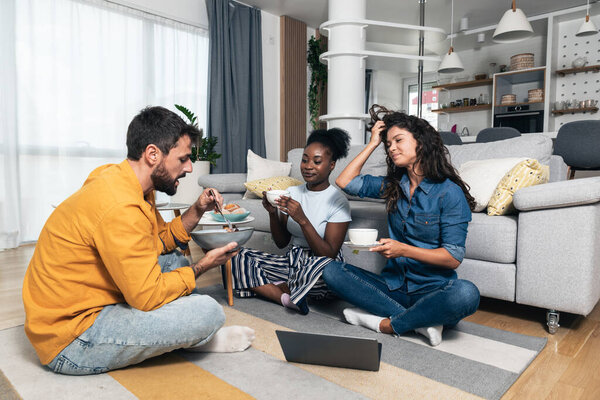 Group of freelancer business partners colleagues working at home on laptop computer. Tree marketing experts chilling and work on new project at the apartment home office.