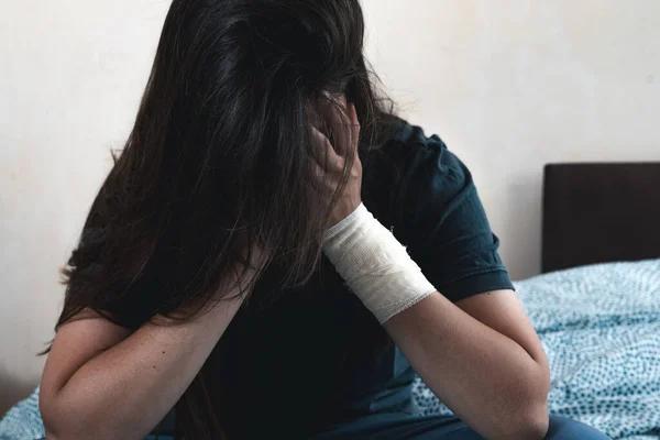 Young Unhappy Woman Bandage Her Hand Hides Her Face Depressed — Stock Photo, Image