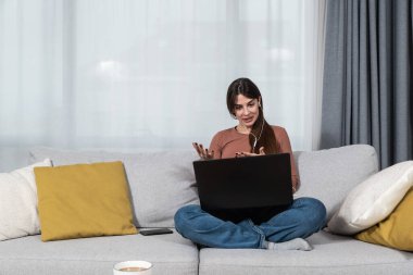 İnternetteki terapi seanslarından sonra psikoterapist doktoruyla görüntülü konuşma yapan genç bir kadın teletıp konuşmalarından sonra iyi ve zihinsel olarak sağlıklı olduğuna seviniyor..